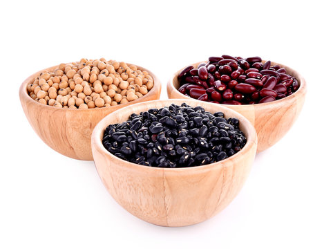 Black beans, red beans, soybeans in wooden bowl on white backgro