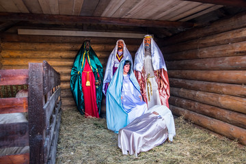 Christmas nativity scene with figures, including Jesus, Mary, Joseph and the Magi.