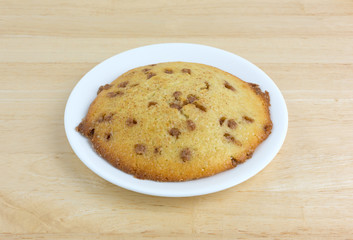 Apple spice muffin top on a plate atop a table.