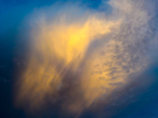 Fototapeta na wymiar yellow cloud in the blue sky