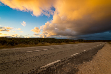 Fototapeta na wymiar Picturesque landscape scene and sunset above road