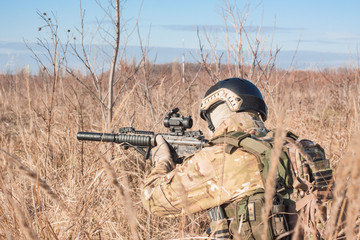 Fototapeta premium Airsoft Soldiers in ambushl during a military simulation training game back view