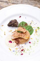 Freshly made italian ravioli pasta with slices of black truffle