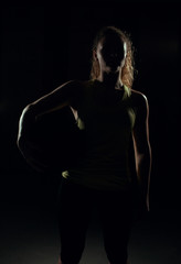 Naklejka premium Young woman stands with the ball.
