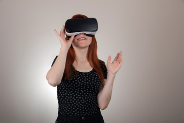  Redhead woman using a virtual reality headset