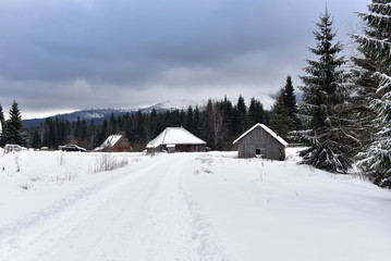 Alpine house covered with snow in the mountains