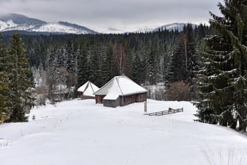 Alpine house covered with snow in the mountains