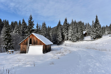 Mountain wooden chalet covered with fresh snow