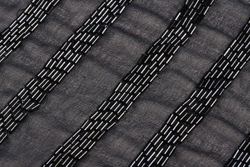 black pearls on a gray fabric