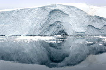 Fototapeta na wymiar Glaciers On Frozen Ocean Against Sky in Greenland