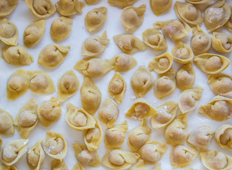 Raw italian cappelletti, fresh homemade pasta stuffed with cheese and meat.
