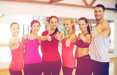 group of people in the gym showing thumbs up