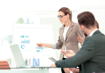 Successful businesswoman in suit at the office leading a group