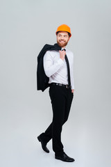 Full length engineer with jacket on shoulder