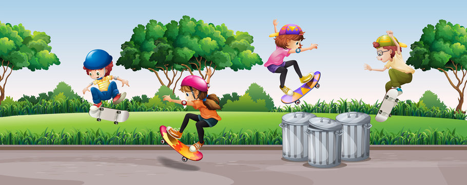 Four kids skateboarding in park