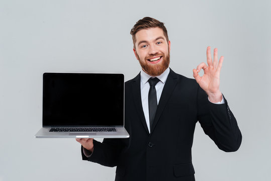Business man showing blank laptop screen