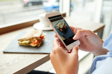 hands with smartphone photographing food