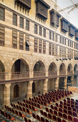 Courtyard of  caravansary (Wikala) of al-Ghuri, with five floors of vaulted arcades leading to storage rooms, and windows covered by interleaved wooden grids (mashrabiya), Medieval Cairo, Egypt