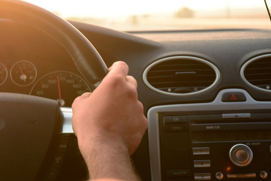 A picture of someone's hand while they are driving