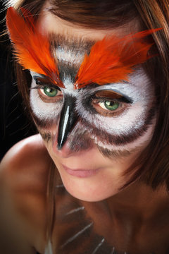 Girl in the mask of an owl, body art