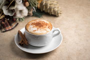 Cappuccino drink with cinnamon christmas decoration background