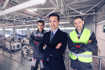Manager and workers in factory
