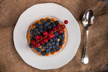 Close-up of blueberry tart on rustic table