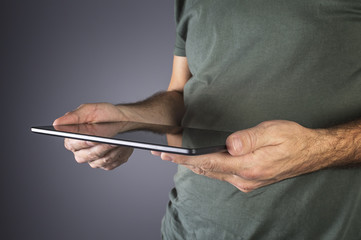 Male hand holding a modern tablet.