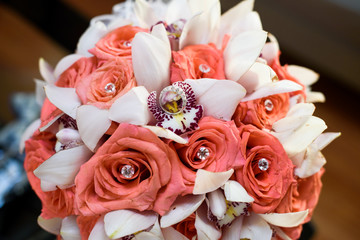 Beautiful wedding ring lies on the top of pink bouquet