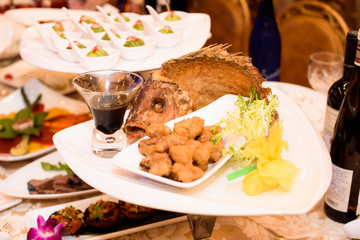 Fish, sauce and greenery served on triangle plate