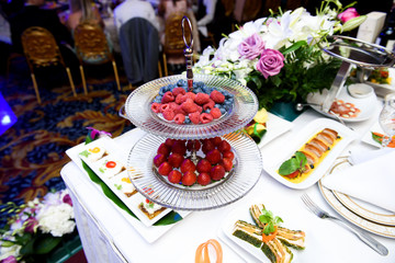 Delicious berries served on tired glass dish