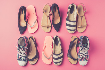 Collection of women's shoes on pink background