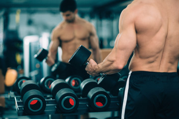 Gym workout - Male athlete exercising in the gym