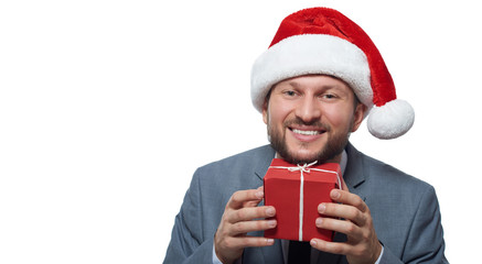 Happy man in a Christmas hat holding a present