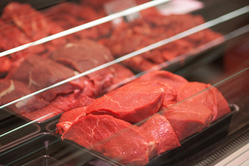 Variety of meat slices in boxes in supermarket