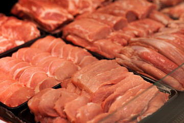 Variety of meat slices in boxes in supermarket