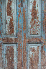 wooden door with flaking blue paint
