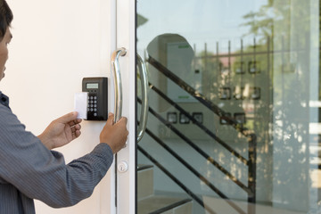 Close-up hand inserting keycard to lock and unlock door - Door a - 129440217