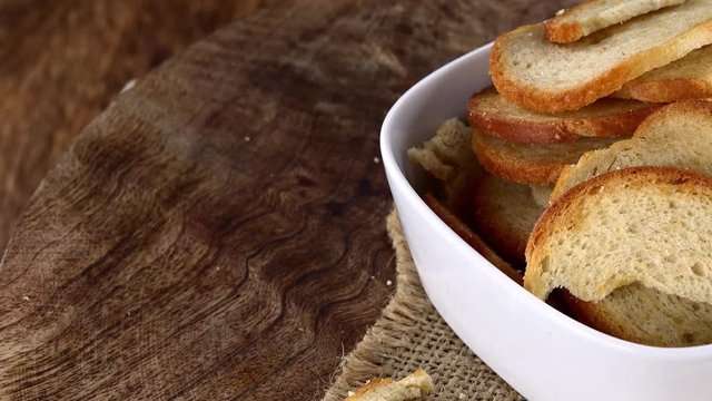 Portion of rotating Bread Chips as seamless loopable 4K UHD footage