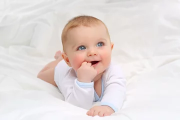Fototapeten Baby in white bedding. © dinaphoto