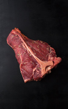 Raw Steak T-Bone with rosemary
