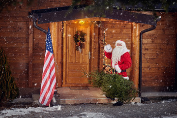 Real Santa Claus front his wooden house