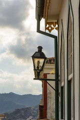 Facade of an old colonial-style house with a lantern outside in Ouro Preto, Minas Gerais