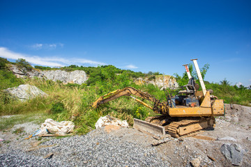 Fototapeta premium yellow backhoe work in field site
