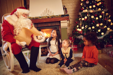 Santa Claus read children's whishes from long paper
