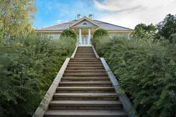 Pushkin Mountains, stairs leading to house of the poet on background blue sky