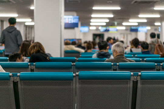 Unidentified people waiting at the airplane boarding gates at airport
