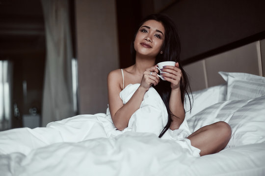 Portrait of a beautiful sensual asian woman with coffee