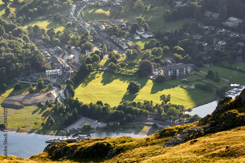 Wall mural Sun setting over Lake District village of Glenridding at sunset.