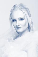 blonde in a white dress with blue makeup. The Snow Queen.